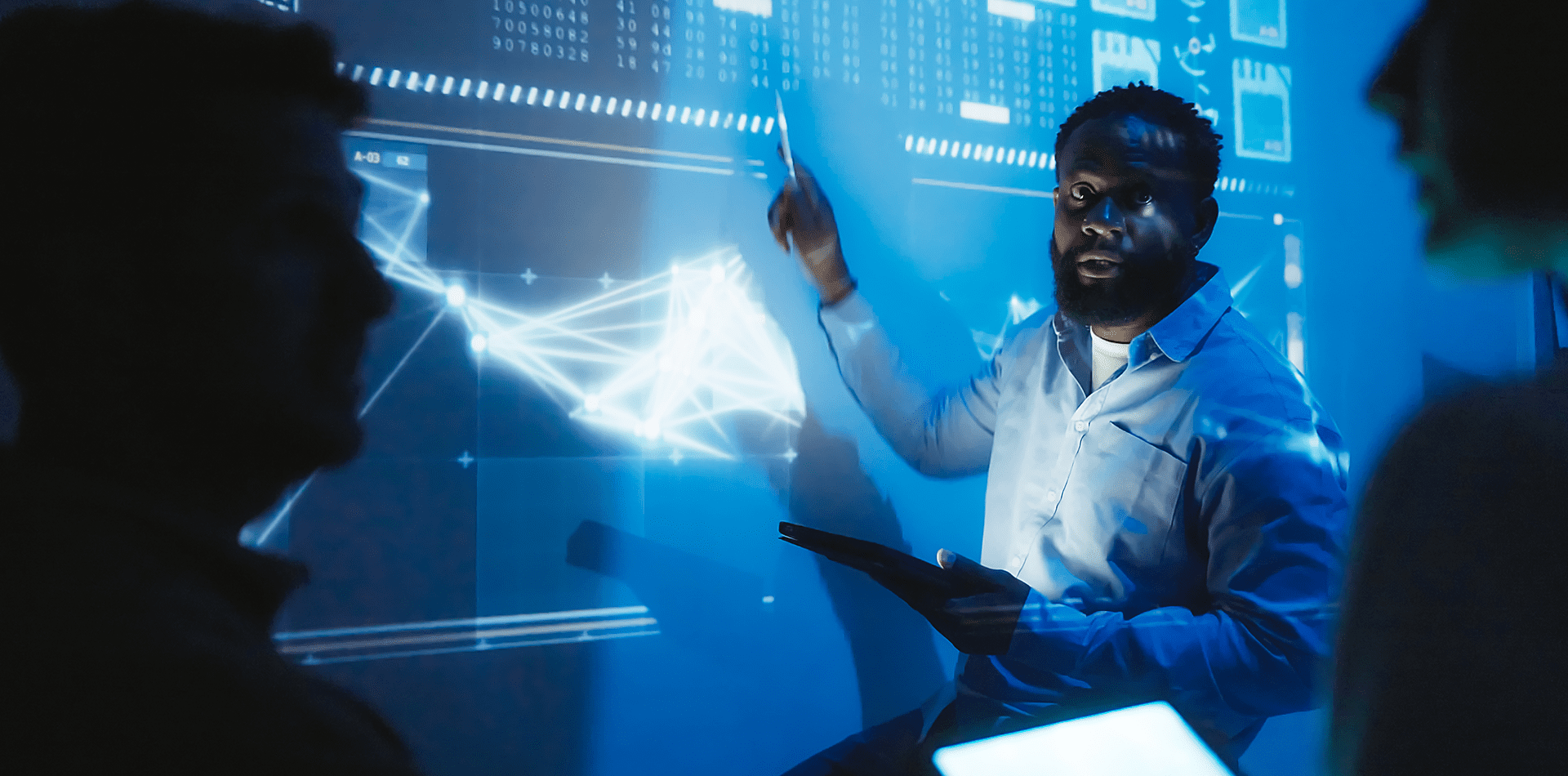 Man presenting data on digital screen.